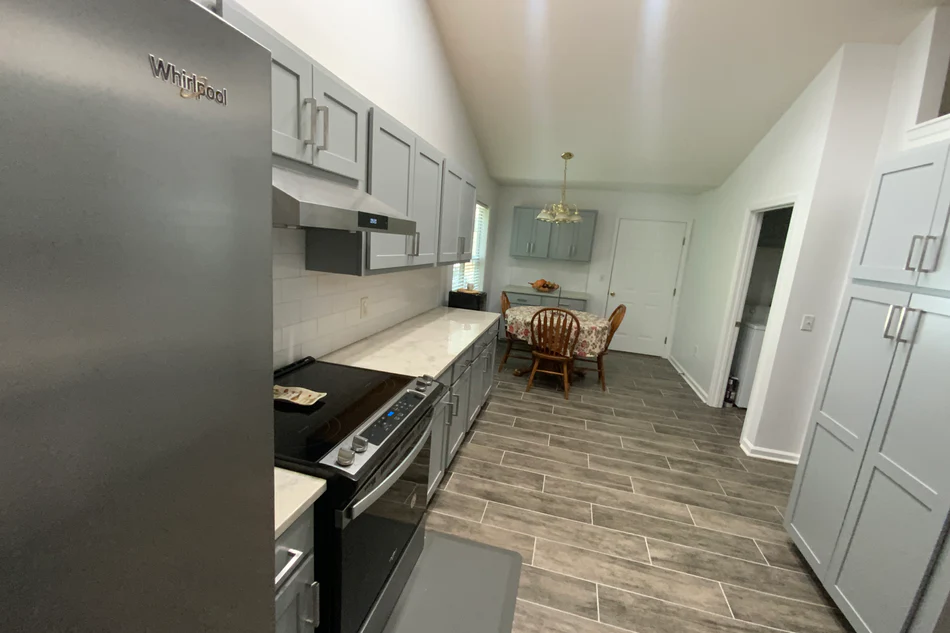 kitchen with flat gray pantry and cabinets
