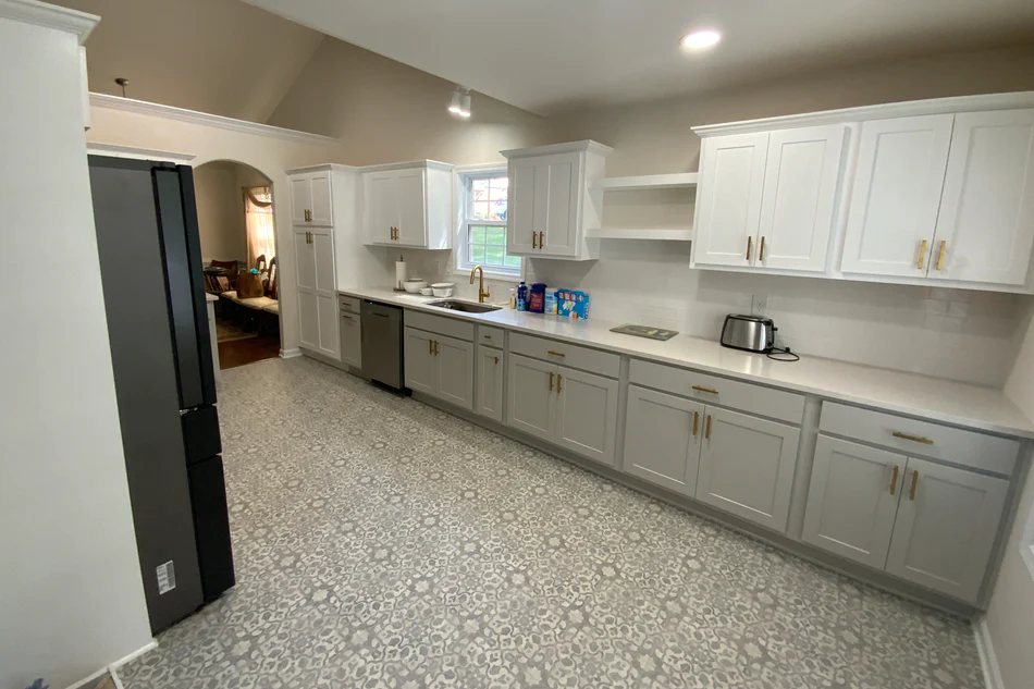 Galley-style kitchen remodel with white cabinets and gold hardware built by A New Day Construction.
